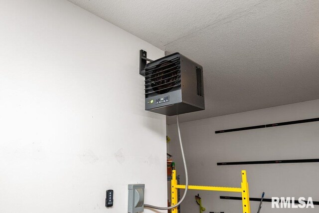 interior space featuring a textured ceiling and a heating unit
