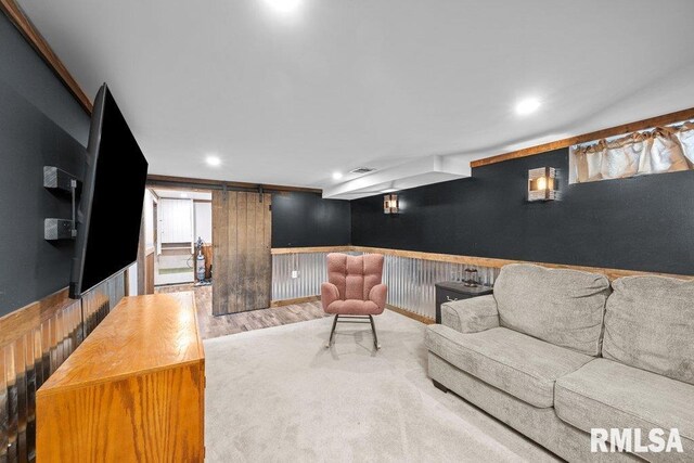 1117 S Ohio Ave, Davenport, IA 52802 - living room featuring a wainscoted wall, wood finished floors, recessed lighting, and a barn door