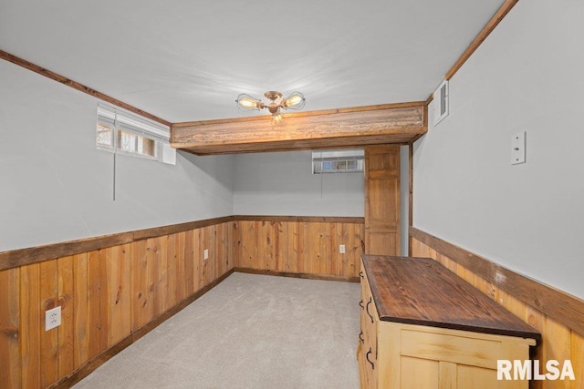 1117 S Ohio Ave, Davenport, IA 52802 - interior space featuring wainscoting, light carpet, visible vents, and wooden walls