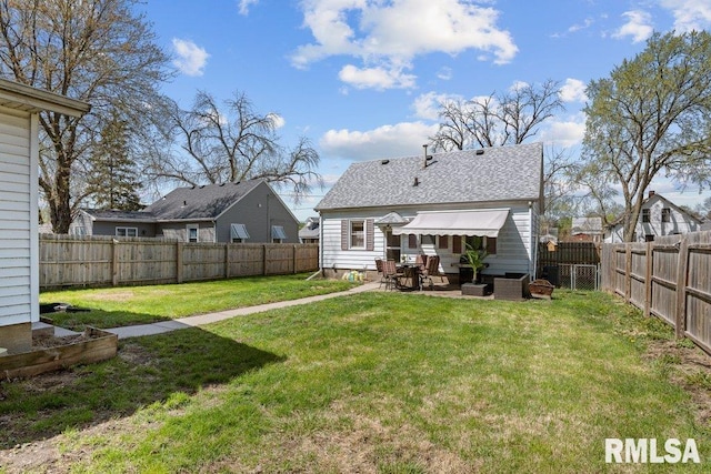 1117 S Ohio Ave, Davenport, IA 52802 - back of house with a lawn, a patio, and a fenced backyard