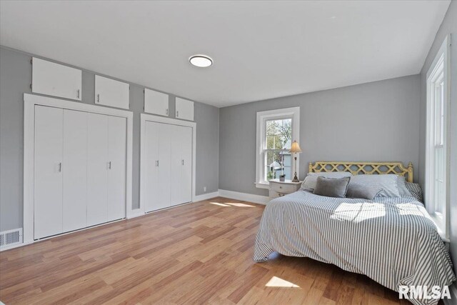 608 S Oakwood Ave, Geneseo, IL 61254 - bedroom featuring light wood-type flooring, multiple closets, and baseboards