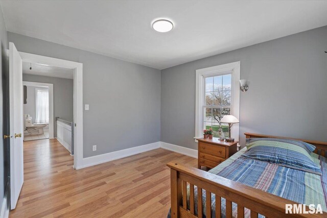 608 S Oakwood Ave, Geneseo, IL 61254 - bedroom featuring multiple windows, light wood finished floors, and baseboards