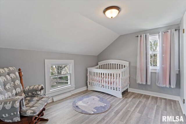 608 S Oakwood Ave, Geneseo, IL 61254 - bedroom with wood finished floors, vaulted ceiling, and baseboards