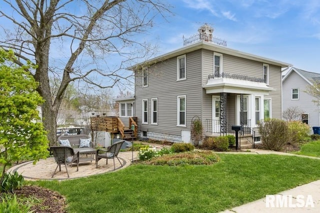 back of house with a chimney, a yard, and a patio