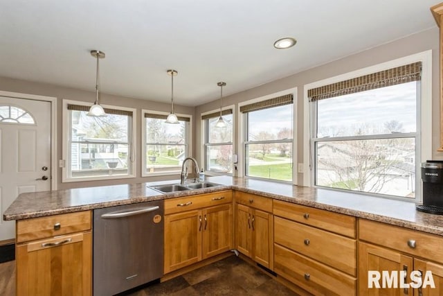 kitchen with a wealth of natural light, dishwasher, pendant lighting, and a sink