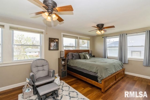bedroom featuring dark wood-type flooring, a ceiling fan, and baseboards