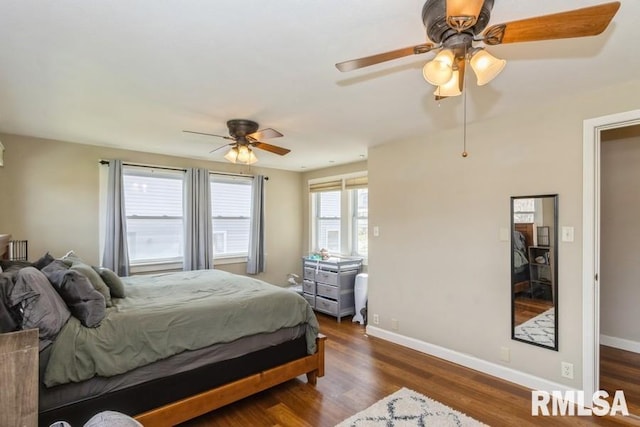 bedroom featuring a ceiling fan, baseboards, and dark wood-style flooring