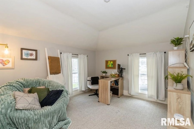 home office with light carpet and vaulted ceiling