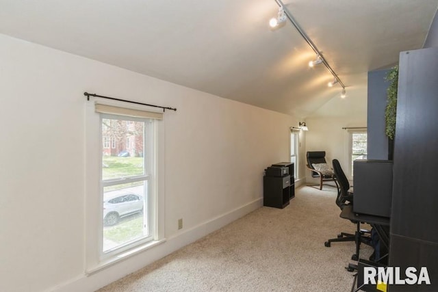 office space with vaulted ceiling, carpet flooring, a wealth of natural light, and rail lighting