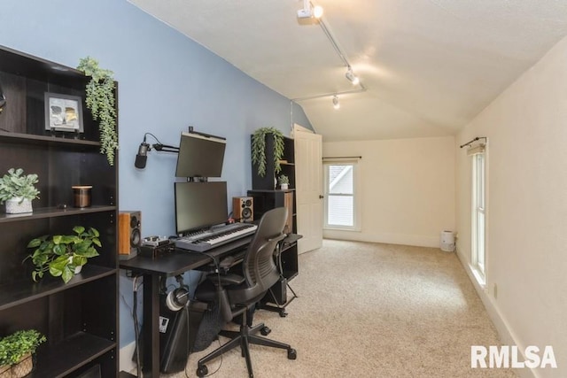 carpeted home office featuring lofted ceiling, baseboards, and rail lighting