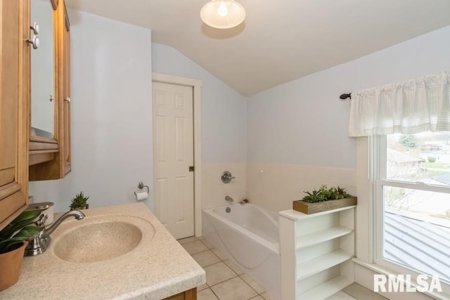 full bathroom with lofted ceiling, a garden tub, tile patterned flooring, and vanity