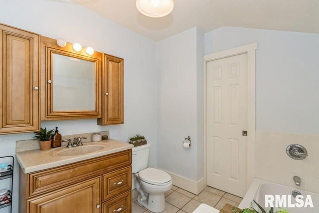full bath featuring tile patterned flooring, vanity, a bathtub, and toilet