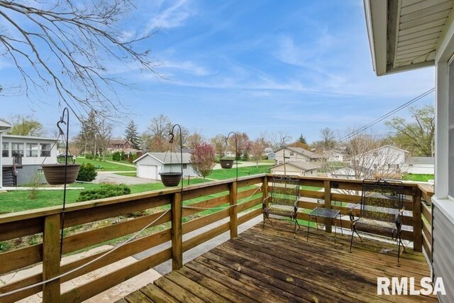 deck featuring an outbuilding and a residential view