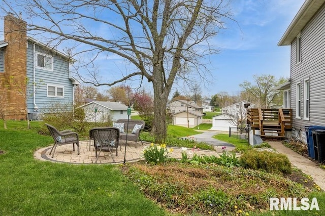 view of yard with a residential view, a patio, central AC unit, and a deck