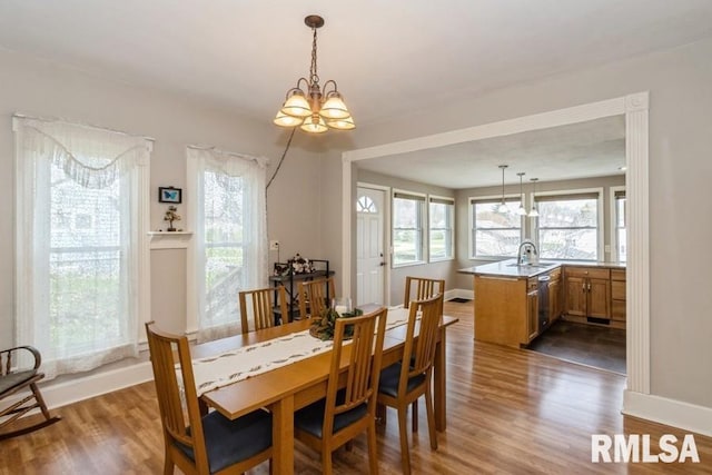 dining room with an inviting chandelier, wood finished floors, and baseboards