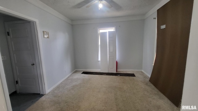 unfurnished room featuring baseboards, a ceiling fan, and carpet flooring