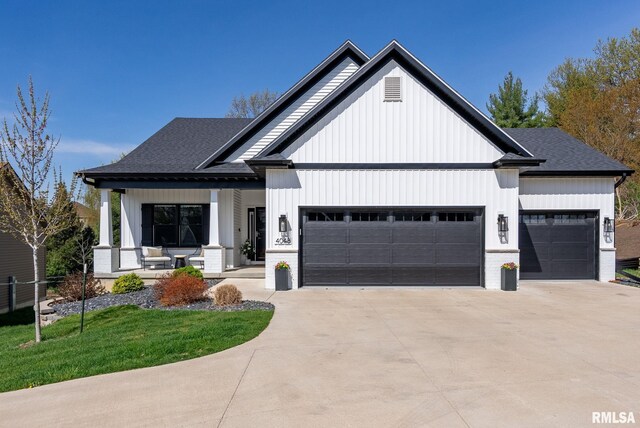 4048 Meadowlark Ct, Bettendorf, IA 52722 - modern farmhouse with covered porch, a shingled roof, driveway, and an attached garage