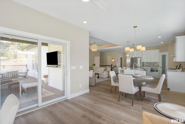4048 Meadowlark Ct, Bettendorf, IA 52722 - dining room with recessed lighting, light wood-style flooring, a chandelier, and baseboards