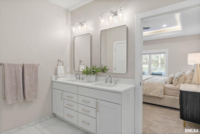 4048 Meadowlark Ct, Bettendorf, IA 52722 - ensuite bathroom featuring a sink, a raised ceiling, marble finish floor, double vanity, and ensuite bathroom