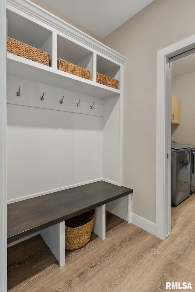 4048 Meadowlark Ct, Bettendorf, IA 52722 - mudroom featuring light wood-type flooring, separate washer and dryer, and baseboards