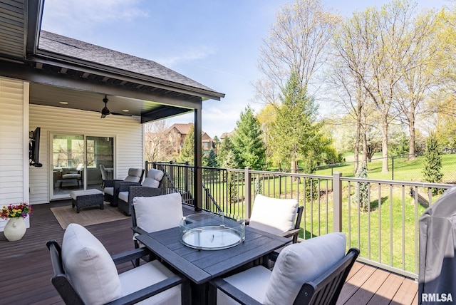 4048 Meadowlark Ct, Bettendorf, IA 52722 - wooden deck featuring fence, outdoor dining space, a lawn, a ceiling fan, and an outdoor living space
