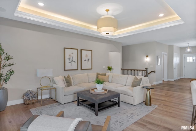 4048 Meadowlark Ct, Bettendorf, IA 52722 - living room with a raised ceiling, recessed lighting, light wood-style flooring, and baseboards