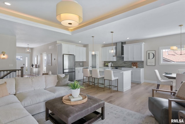 4048 Meadowlark Ct, Bettendorf, IA 52722 - living room featuring recessed lighting, an inviting chandelier, light wood-style flooring, and a healthy amount of sunlight