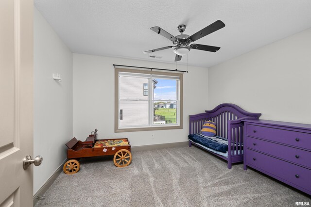 carpeted bedroom with ceiling fan and baseboards