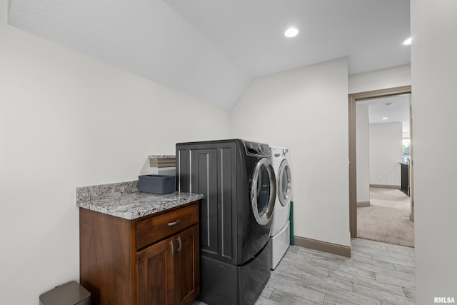 clothes washing area with washing machine and clothes dryer, light wood-style flooring, baseboards, recessed lighting, and laundry area