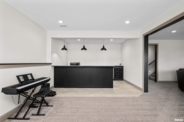 interior space featuring recessed lighting, bar, light carpet, and baseboards