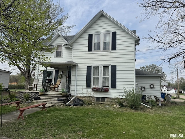 back of property featuring a yard