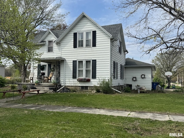 view of front of property with roof with shingles and a front lawn