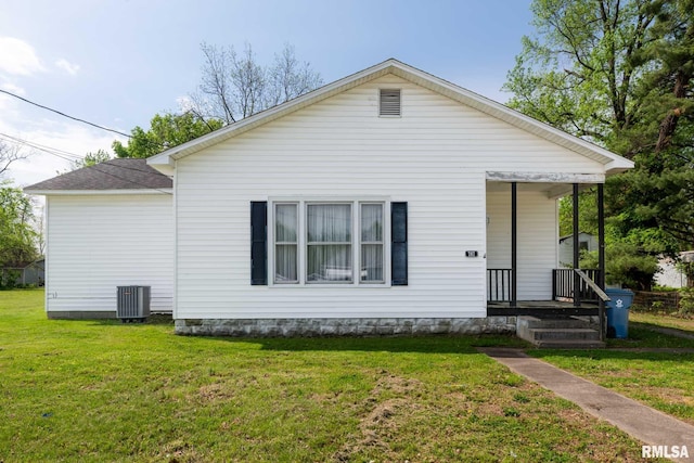 view of front of house with covered porch, cooling unit, and a front lawn