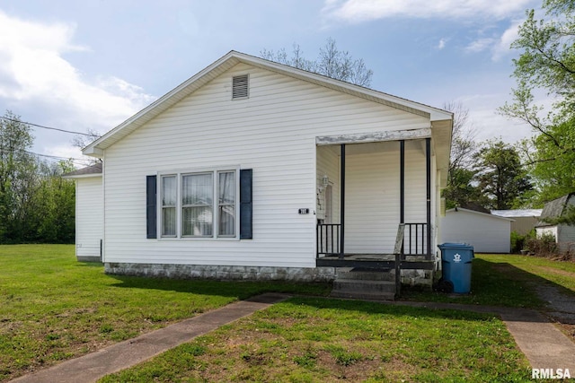 bungalow-style home with a front yard