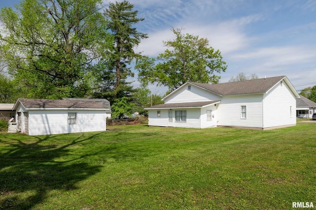 rear view of property featuring a yard