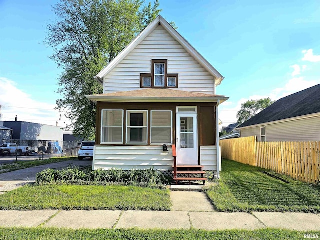 1731 W 5th St, Davenport, IA 52802 - view of front of house featuring fence, a sunroom, and entry steps