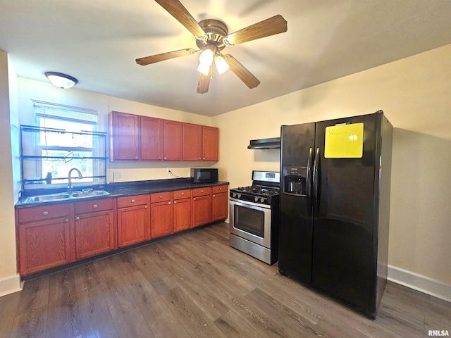 1731 W 5th St, Davenport, IA 52802 - kitchen featuring black appliances, a sink, dark countertops, dark wood finished floors, and baseboards