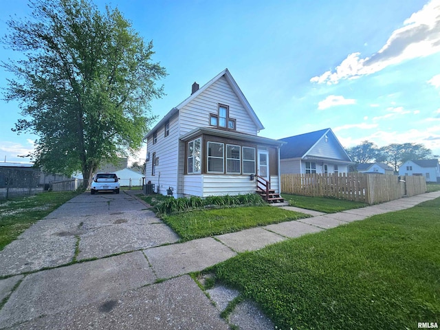 1731 W 5th St, Davenport, IA 52802 - view of front of property with asphalt driveway, a chimney, and entry steps
