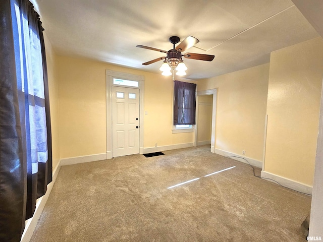 1731 W 5th St, Davenport, IA 52802 - foyer with a ceiling fan, baseboards, and carpet