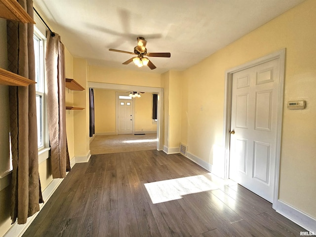 1731 W 5th St, Davenport, IA 52802 - empty room with ceiling fan, dark wood-style floors, and baseboards