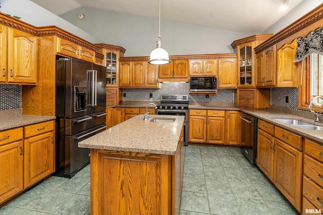kitchen featuring brown cabinets, black appliances, a sink, and vaulted ceiling