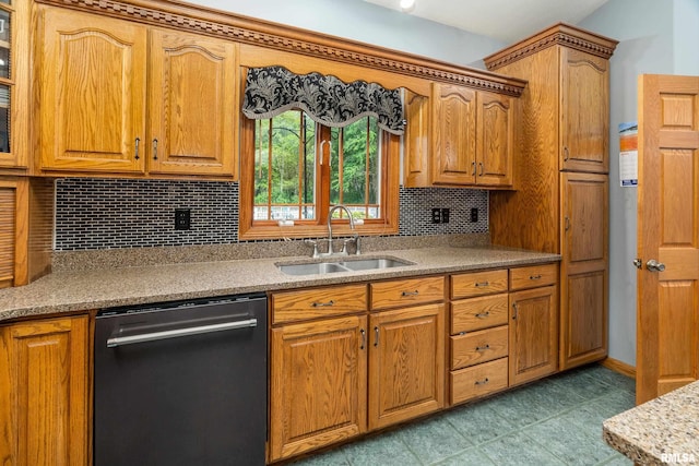 kitchen featuring brown cabinetry, dishwashing machine, decorative backsplash, and a sink