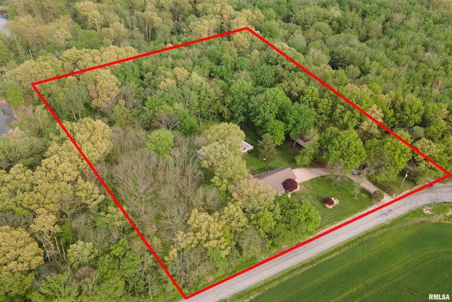 birds eye view of property featuring a view of trees