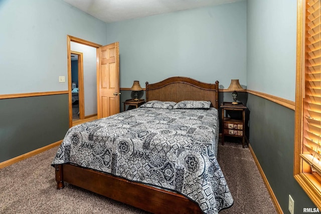 carpeted bedroom featuring baseboards