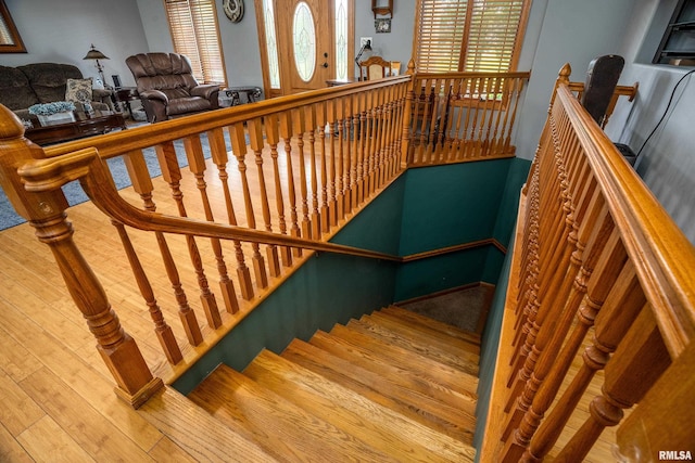 stairs featuring hardwood / wood-style flooring
