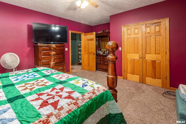 carpeted bedroom with a textured ceiling and a ceiling fan