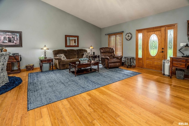 living area featuring wood finished floors and lofted ceiling