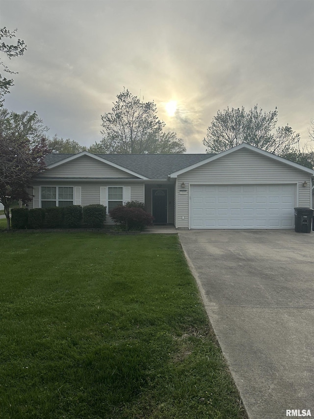 1000 N Almond St, Carbondale, IL 62901 - ranch-style house featuring concrete driveway, a front yard, and an attached garage