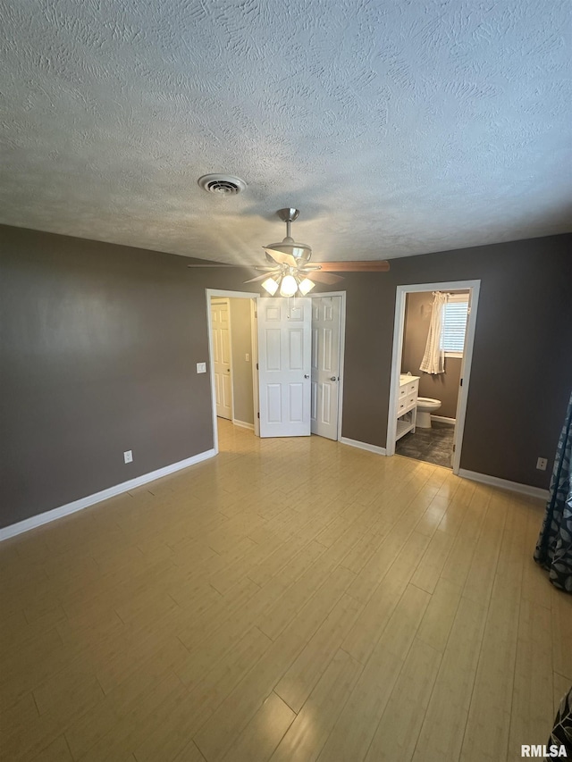 1000 N Almond St, Carbondale, IL 62901 - empty room featuring baseboards, visible vents, a ceiling fan, and a textured ceiling