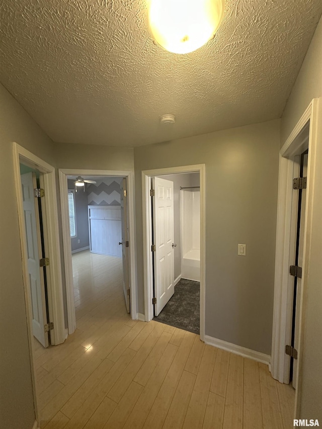 1000 N Almond St, Carbondale, IL 62901 - corridor featuring baseboards, wood finished floors, and a textured ceiling